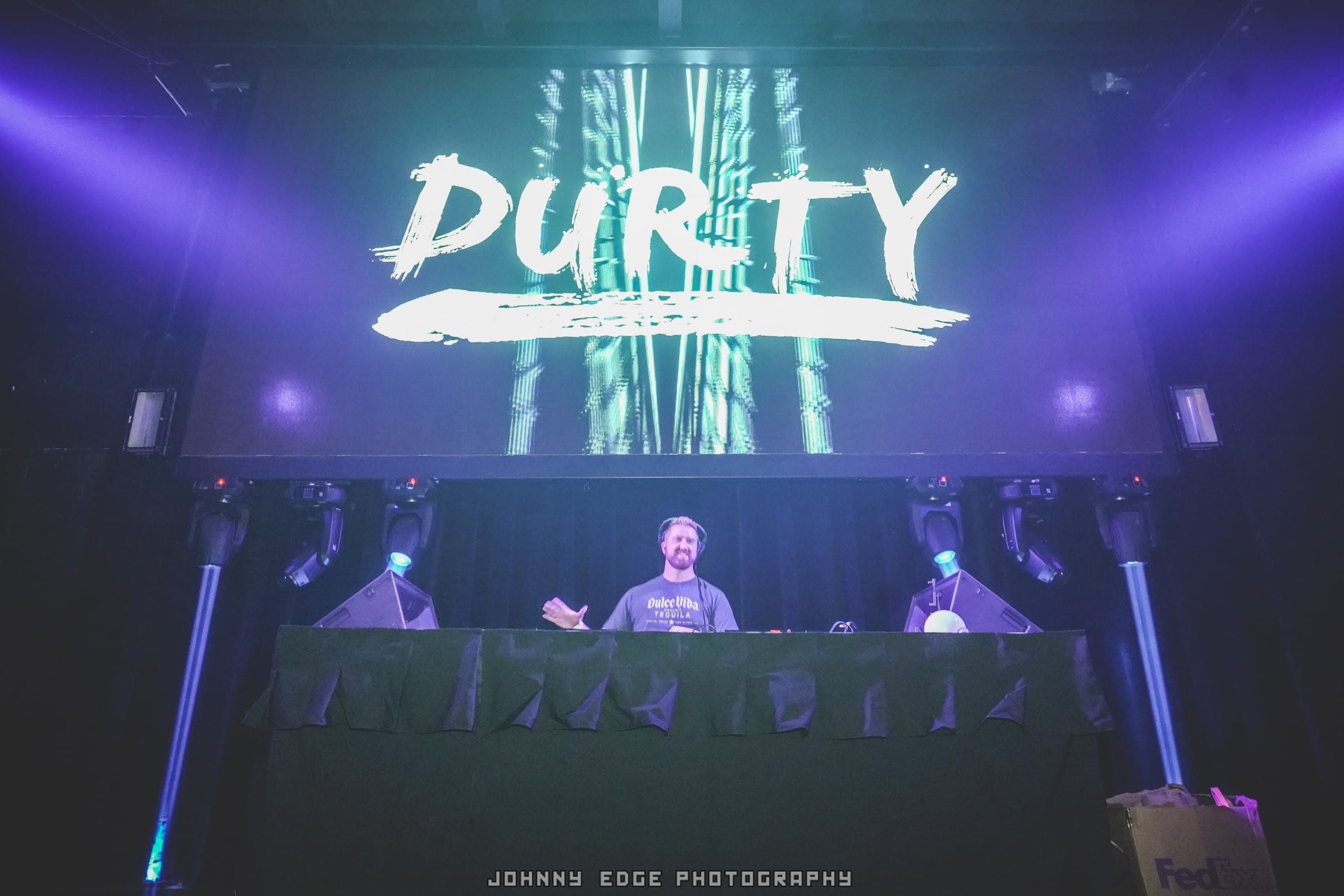 The DURTY brush-script wordmark filling the LED wall behind the DJ booth